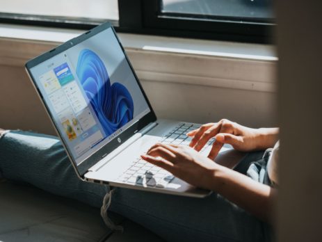 person using Windows 11 computer on lap