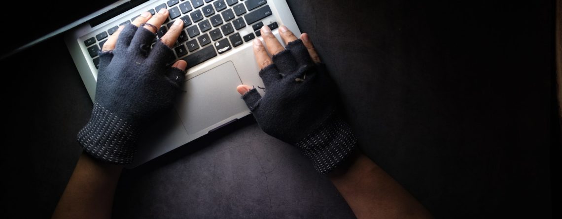 person in black long sleeve shirt using macbook pro