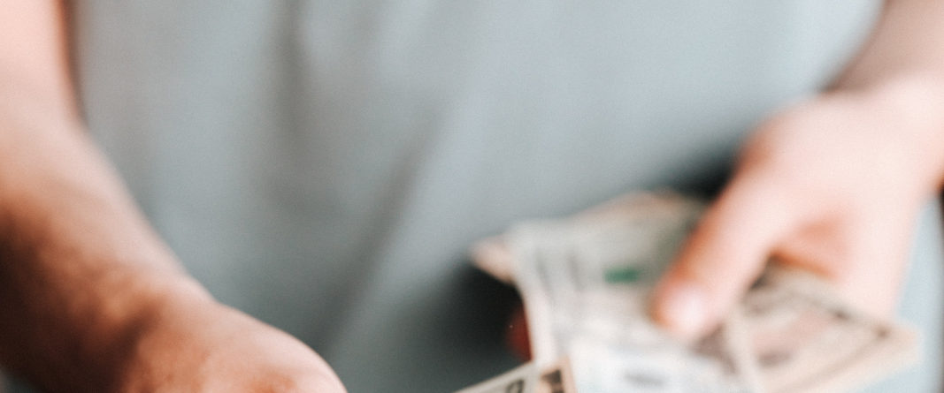 Free Crop man paying with American dollars Stock Photo