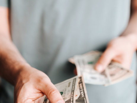 Free Crop man paying with American dollars Stock Photo