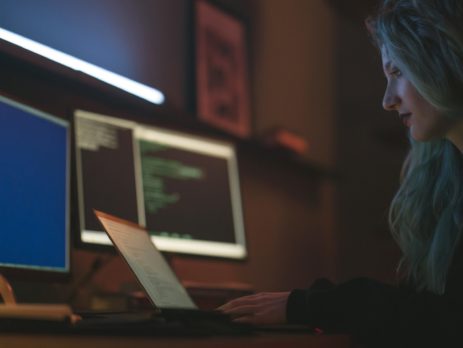 Free Side View of a Woman Using a Laptop Stock Photo