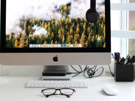 Free Turned on Silver Imac With Might Mouse and Keyboard Stock Photo