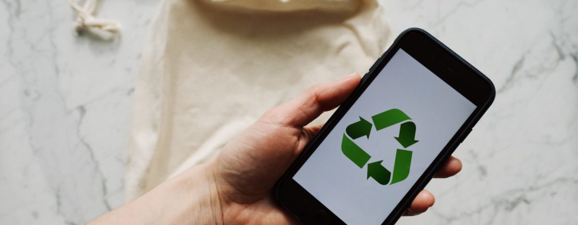 Free Faceless person showing recycle symbol on mobile phone screen Stock Photo